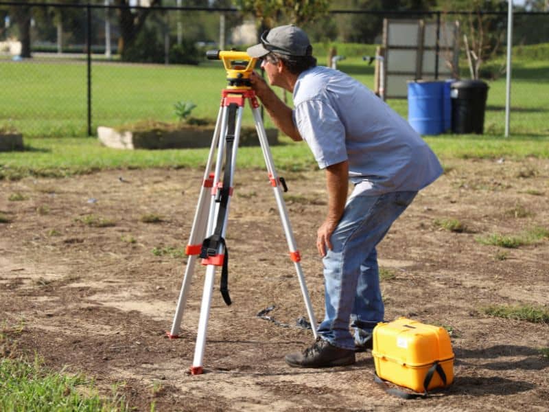 Land survey crew checking a residential property for hidden property problems before construction begins
