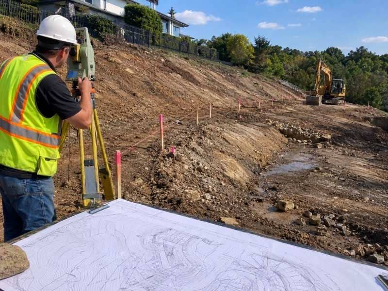 Topo Survey measuring ground elevations and slope changes before retaining wall construction, helping contractors plan wall height, drainage, and foundation depth.